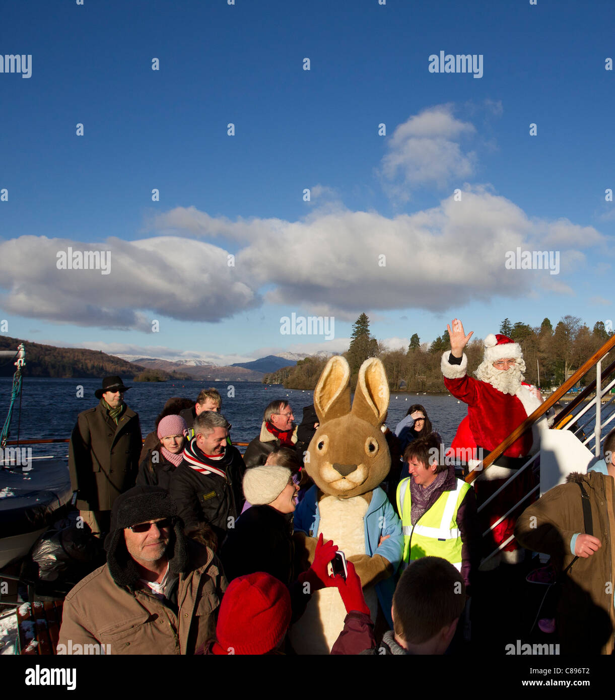 Santa Father Christmas at Bowness Bay bright winters day Lake