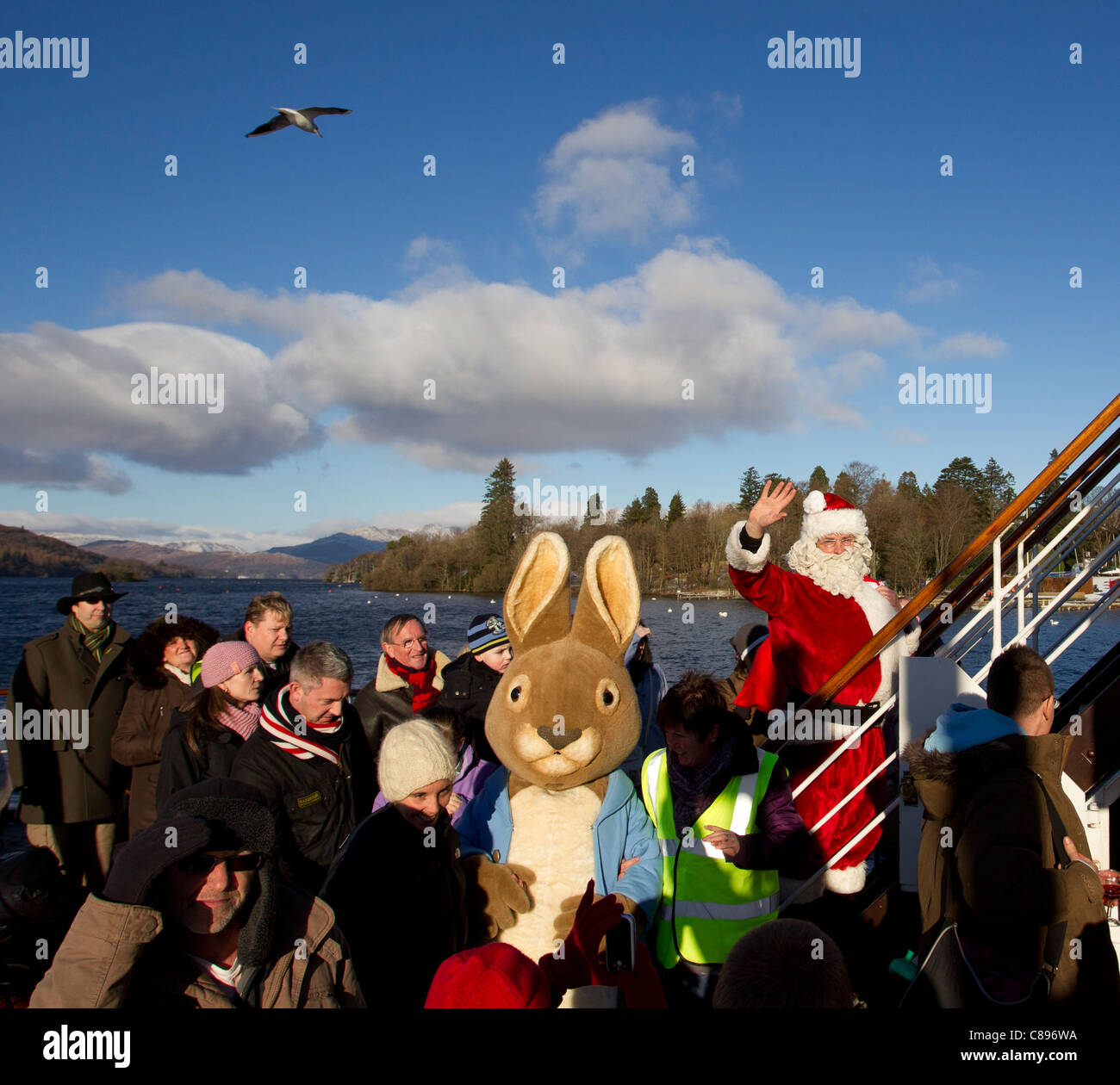 Santa Father Christmas at Bowness Bay bright winters day Lake