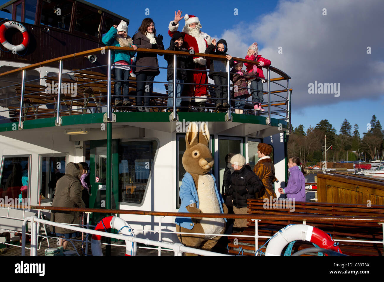 Santa Father Christmas at Bowness Bay bright winters day Lake
