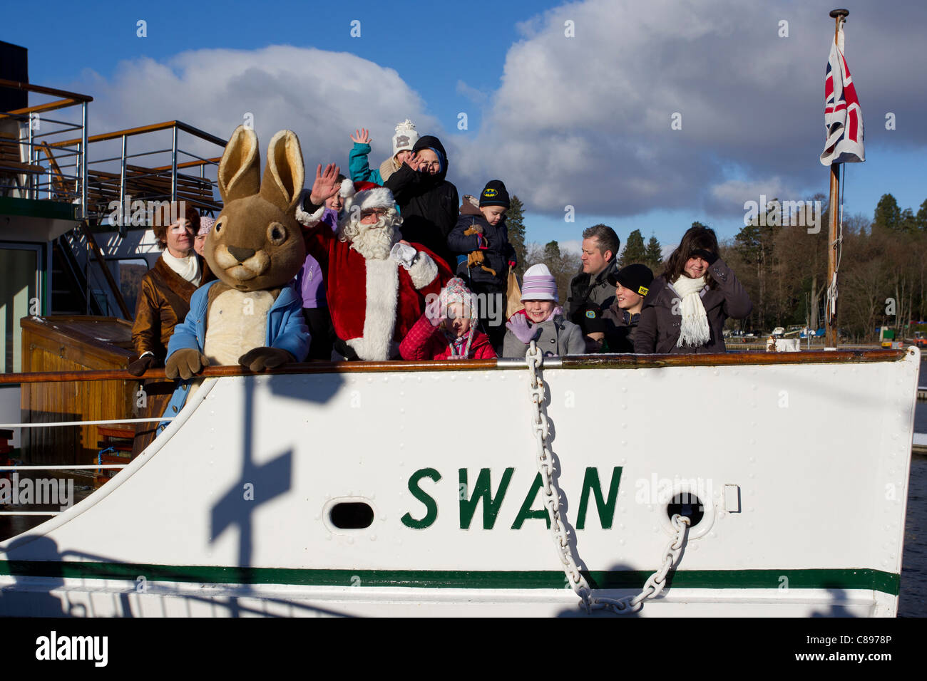 Santa Father Christmas at Bowness Bay bright winters day  Lake Windermere  with Beatrix Potter's Peter Rabbit on the Swan cruise Stock Photo