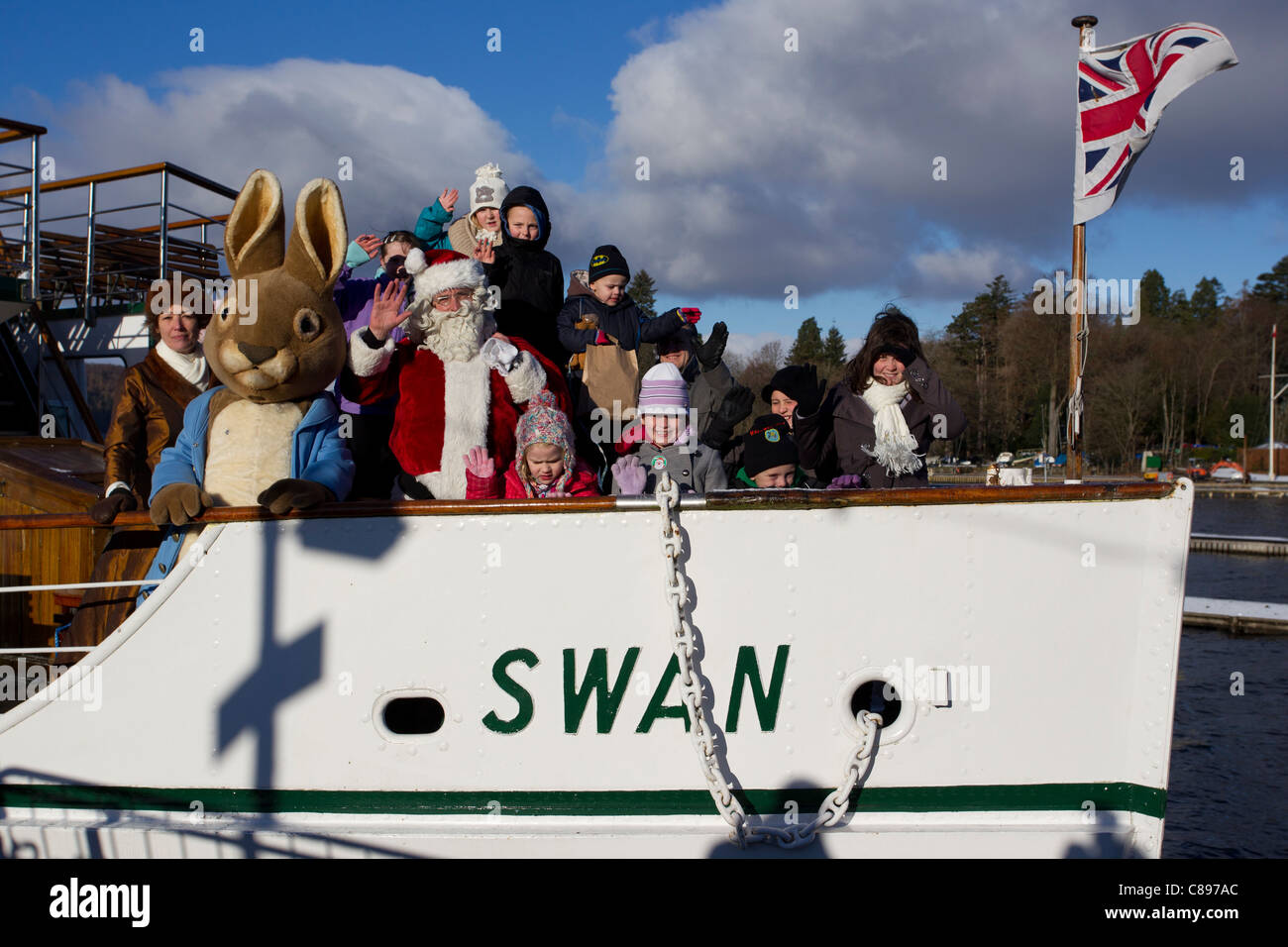 Santa Father Christmas at Bowness Bay bright winters day Lake