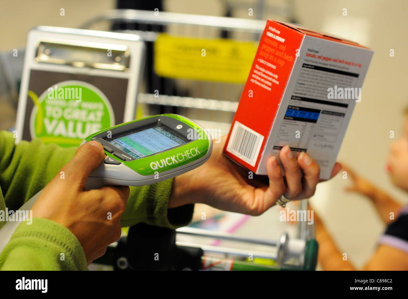 Supermarket shopper using a Waitrose Quick Check self scanner Stock Photo Alamy