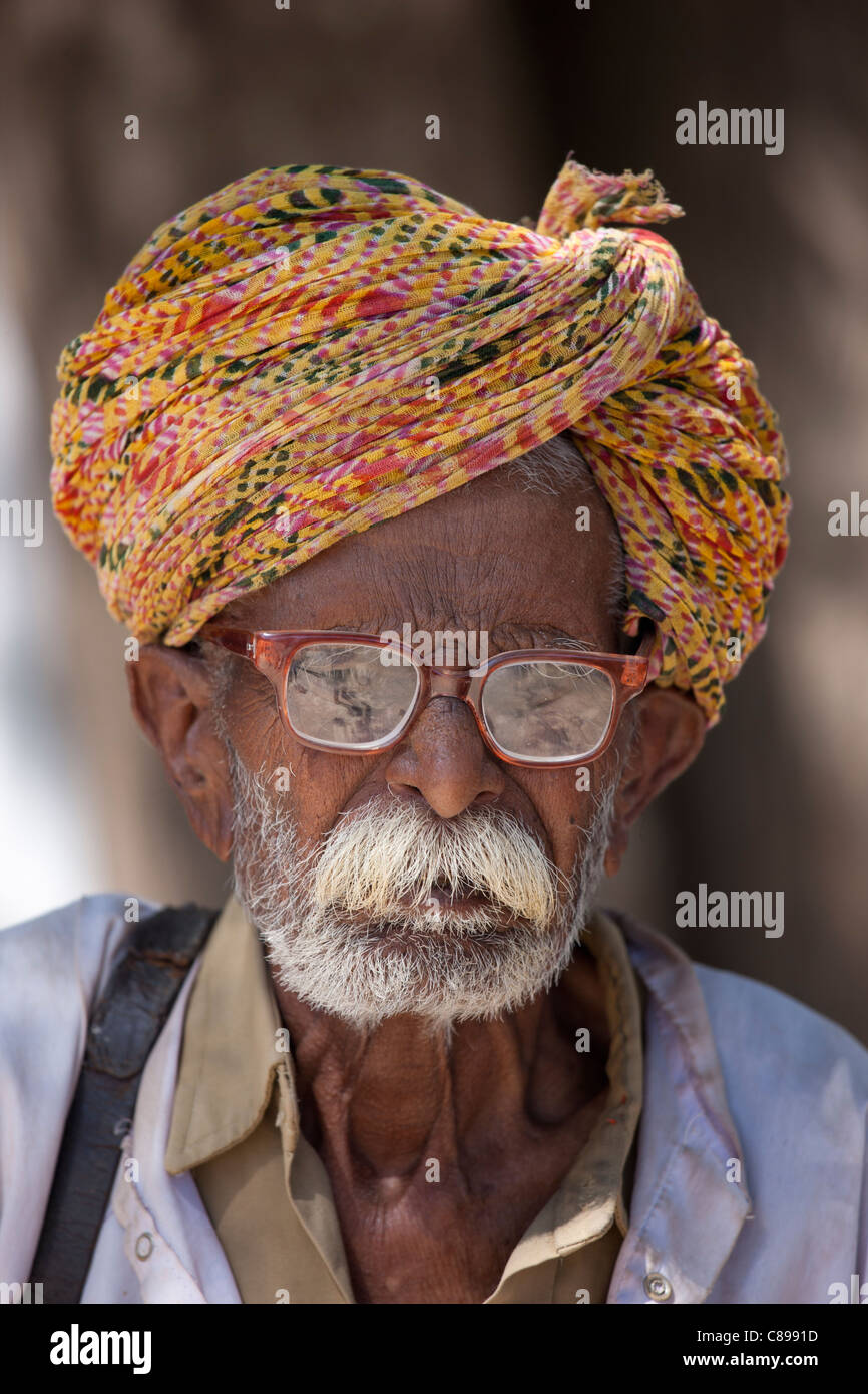 Indian man, the local barber, in typical Rajasthani village of Nimaj, Rajasthan, Northern India Stock Photo