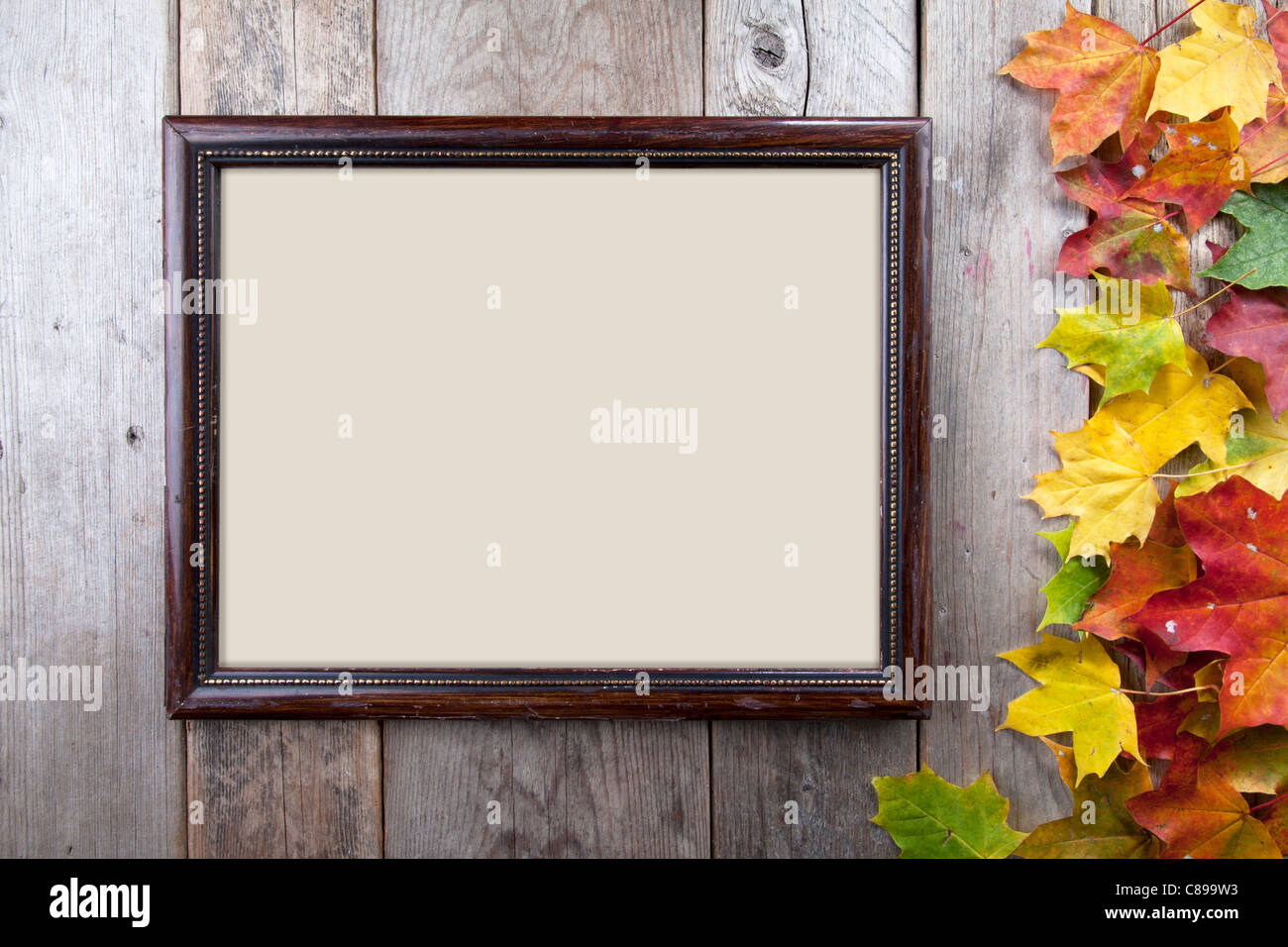 Autumn leaves and frame on wooden background Stock Photo - Alamy