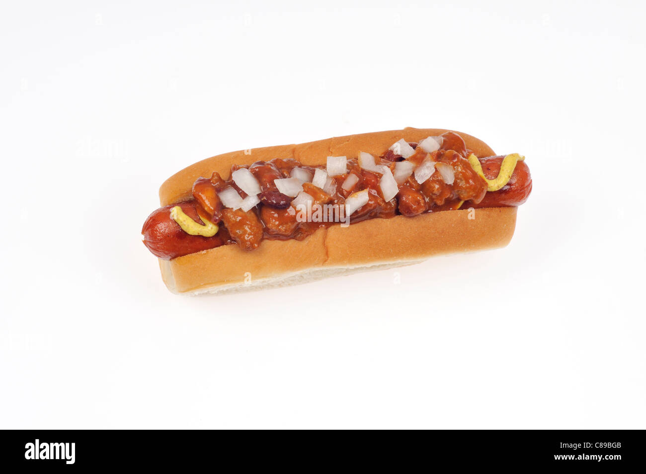 Chili dog with onions and mustard in bread roll on white background cut out Stock Photo
