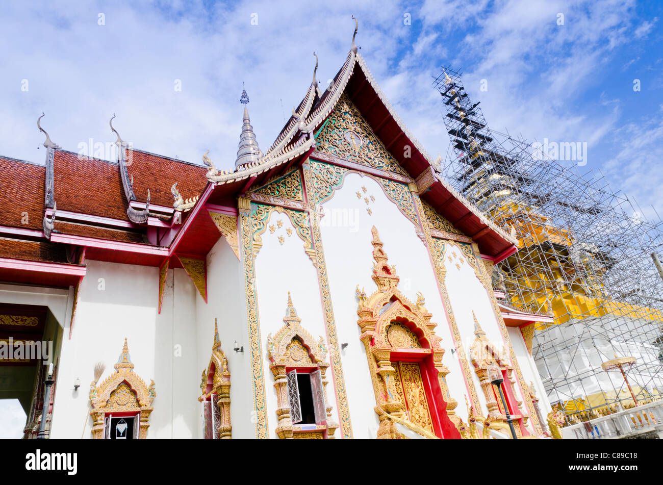 A Buddhist Thai temple sermon hall glistens in sunshine at Wat Doi Saket in northern Thailand Stock Photo