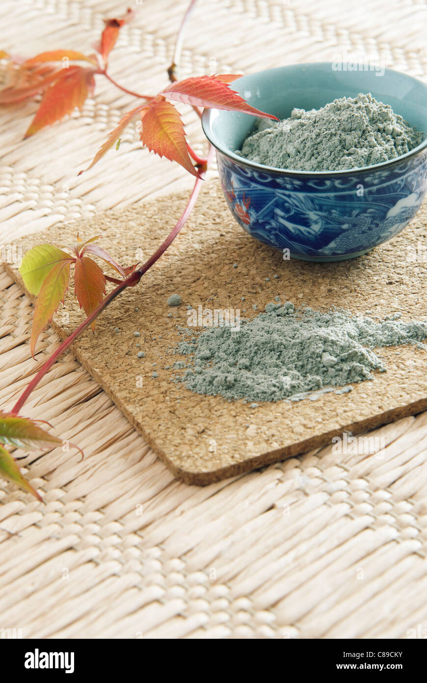 porcelain drinking bowl with powder of cosmetic blue clay Stock Photo
