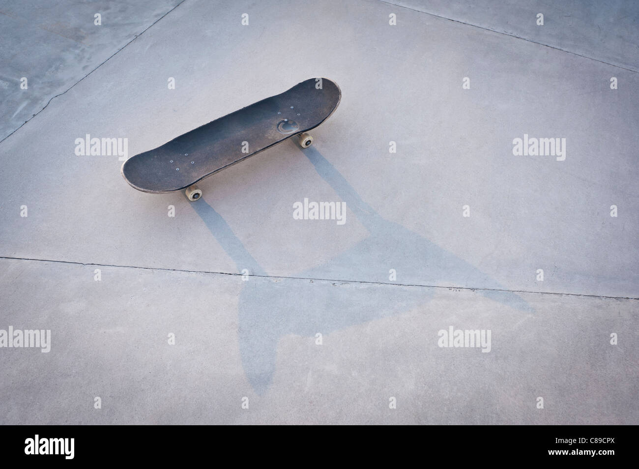 Belgium, Mechelen, Skateboard lying on ground in public skatepark Stock Photo