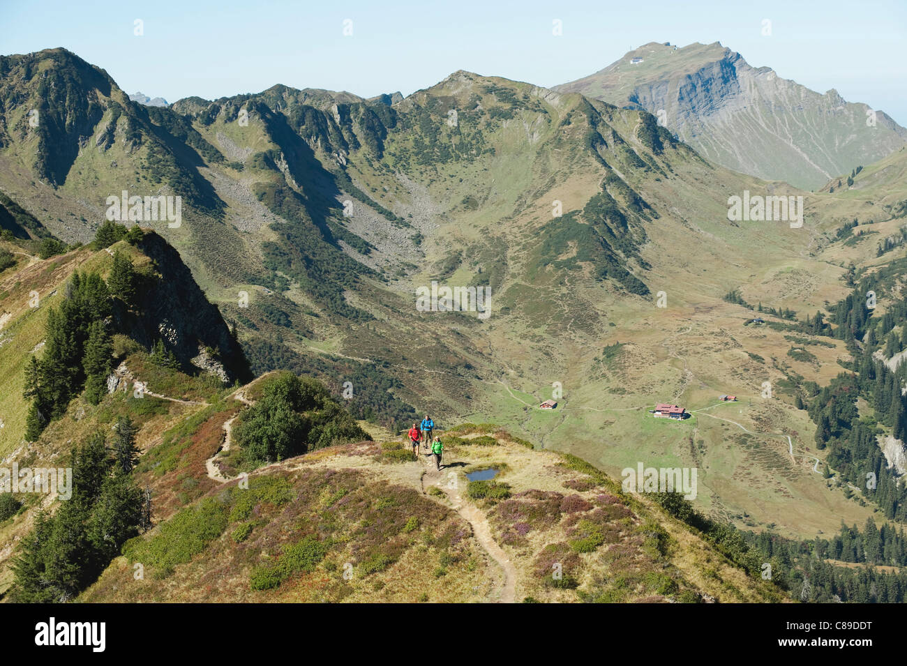 Austria, Kleinwalsertal, Group of people hiking on mountain trail Stock Photo