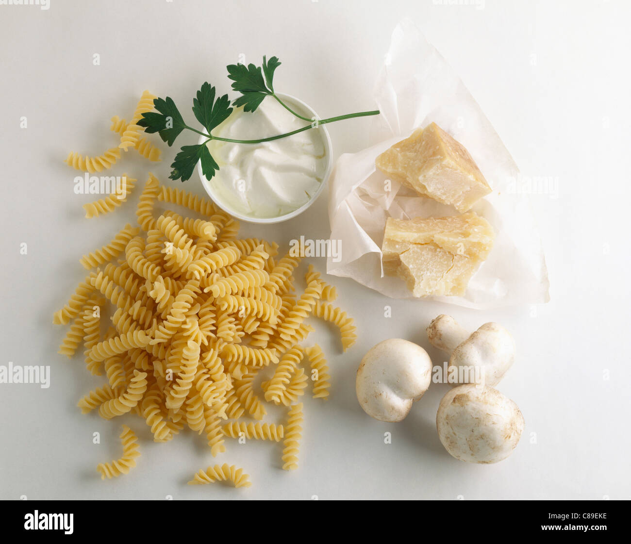 Dry pasta twists, Parmesan and mushroom ingredients Stock Photo Alamy