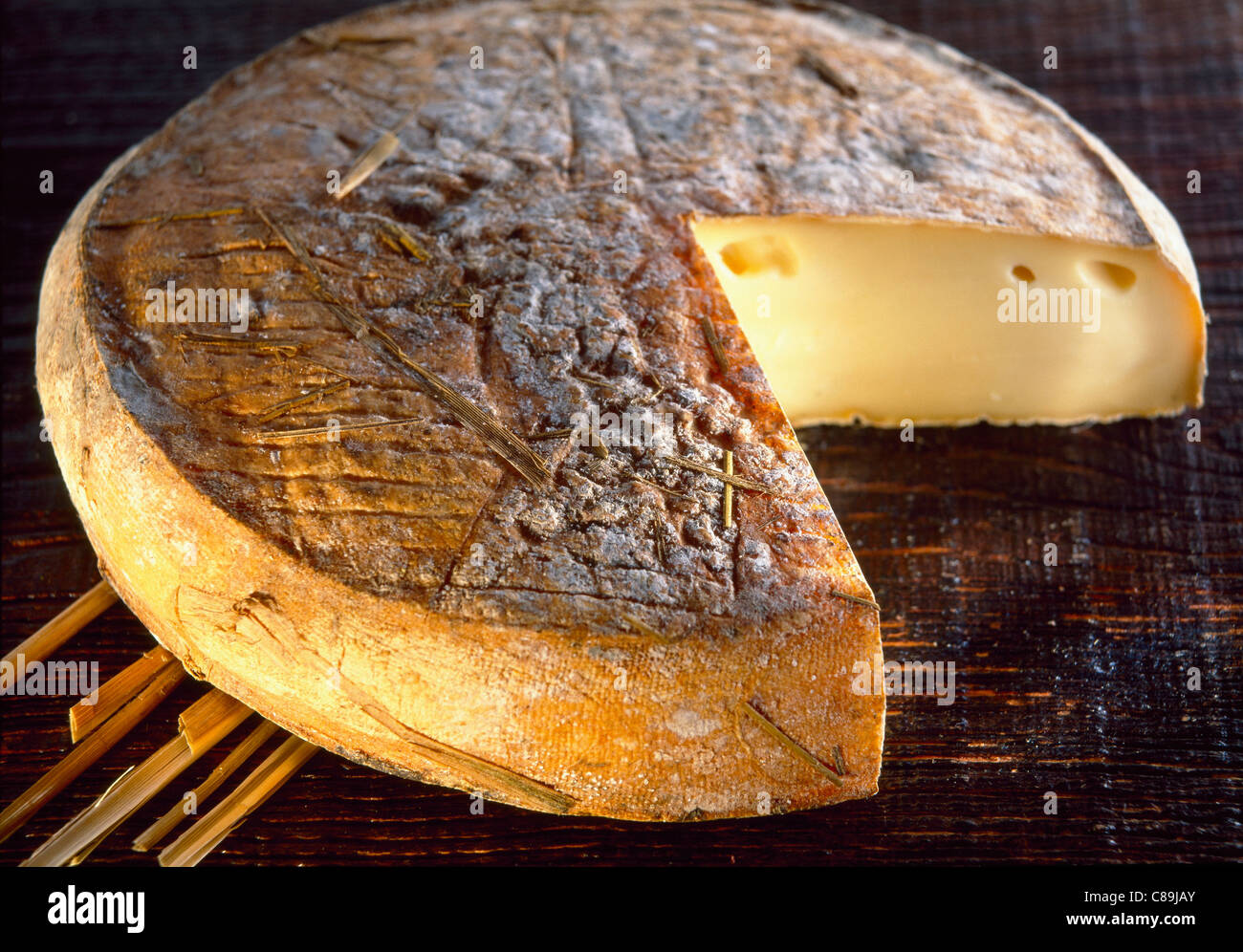 Cut SaintNectaire cheese Stock Photo Alamy