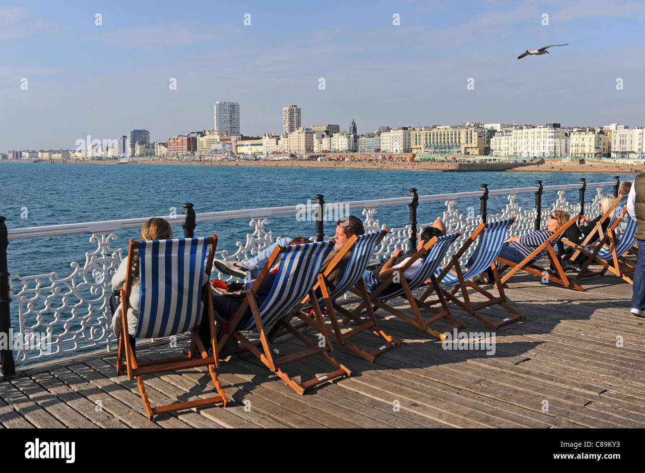 Sunbathing in deckchairs on Brighton Pier or THe Palace Pier as it was known UK Stock Photo