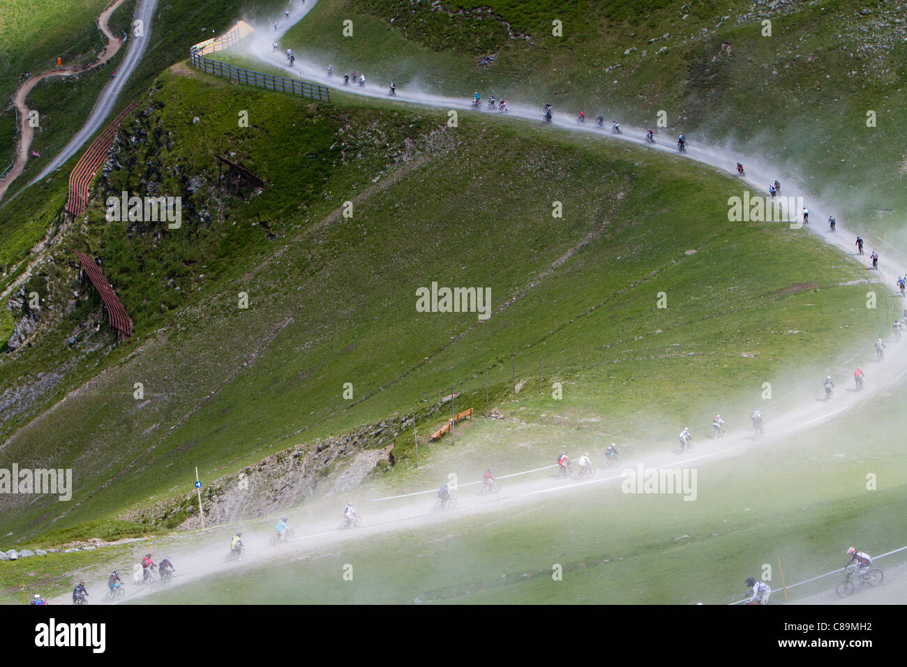 Austria, Salzburger Land, Hinterglemm, View of mountainbike downhill race on dusty gravel road Stock Photo