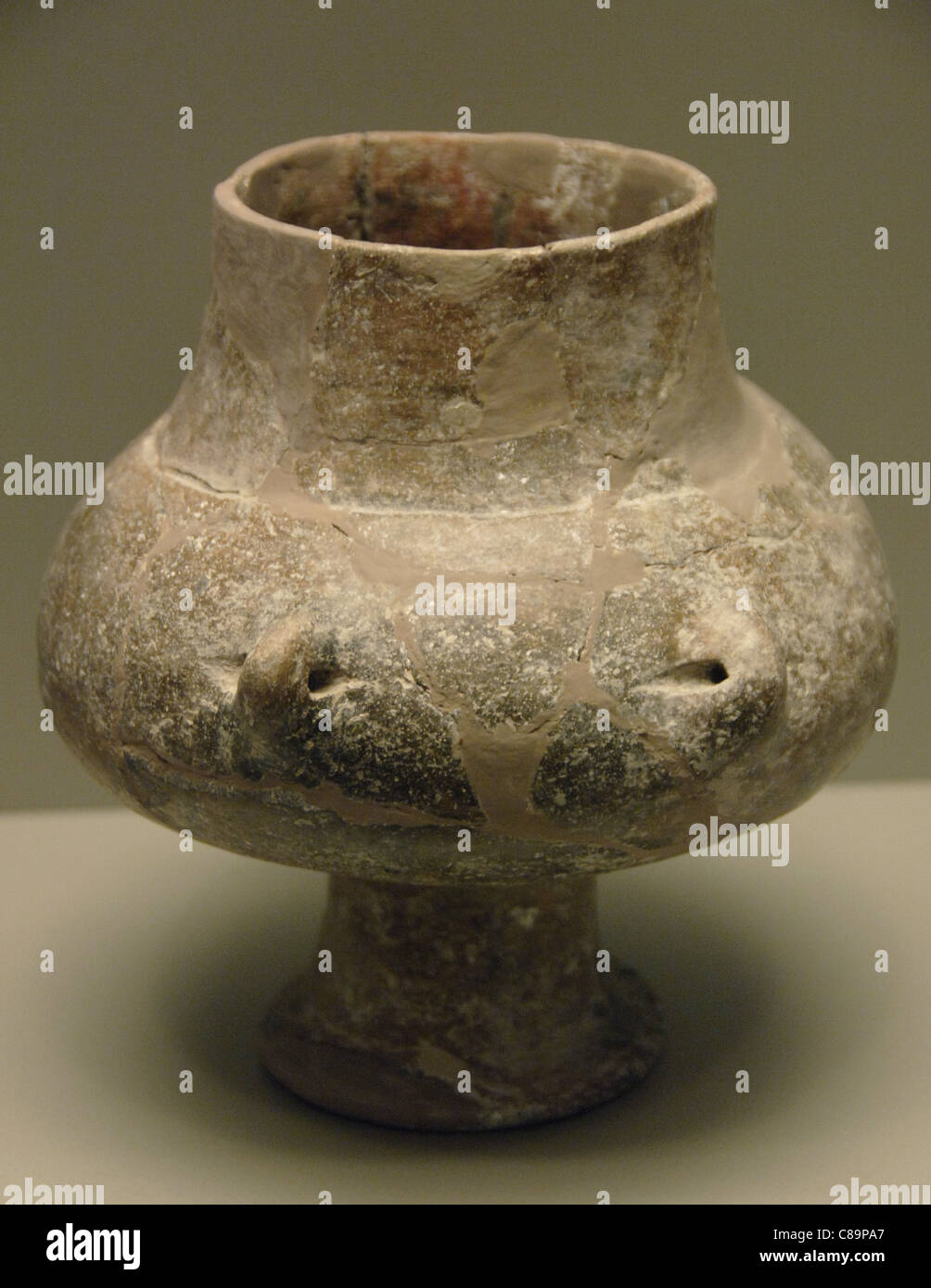 Prehistoric Art. Greece. Handmade vase without decoration. Globular body with two small handles. Stock Photo