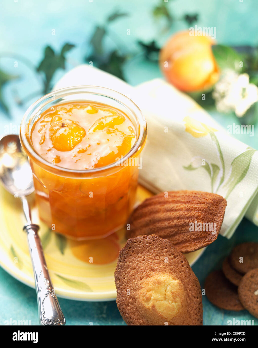 Pot of citrus fruit jam with madeleine cakes Stock Photo Alamy