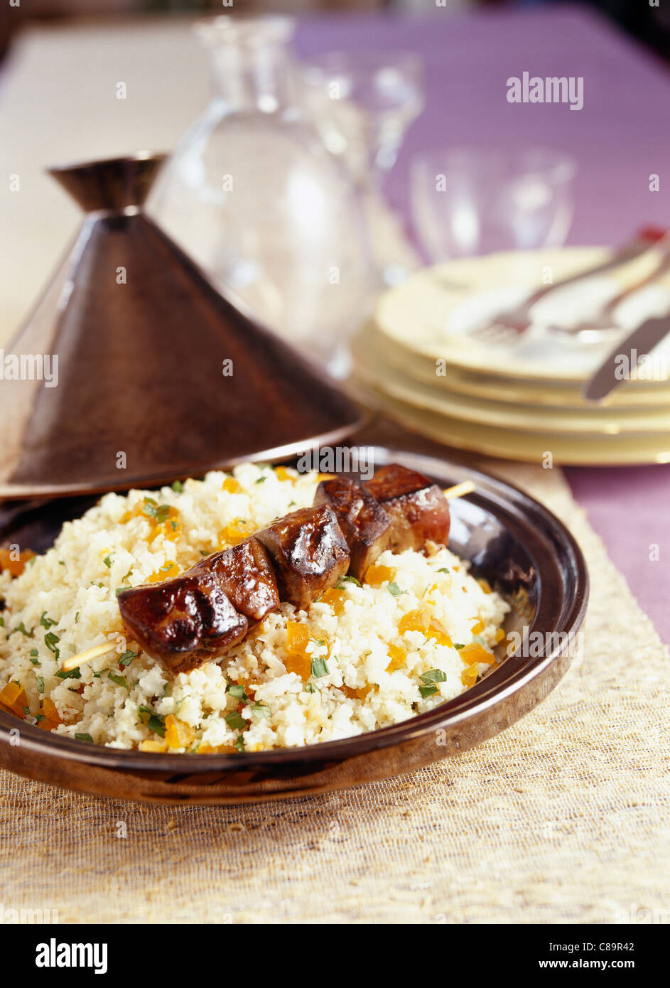 Couscous with cauliflower and dried apricots and foie gras skewer Stock Photo