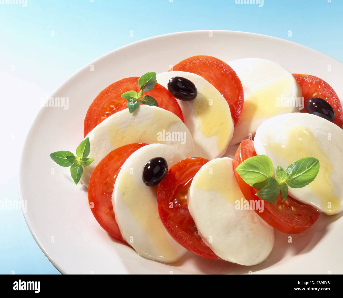 Sliced tomatoes and mozzarella with basil Stock Photo - Alamy