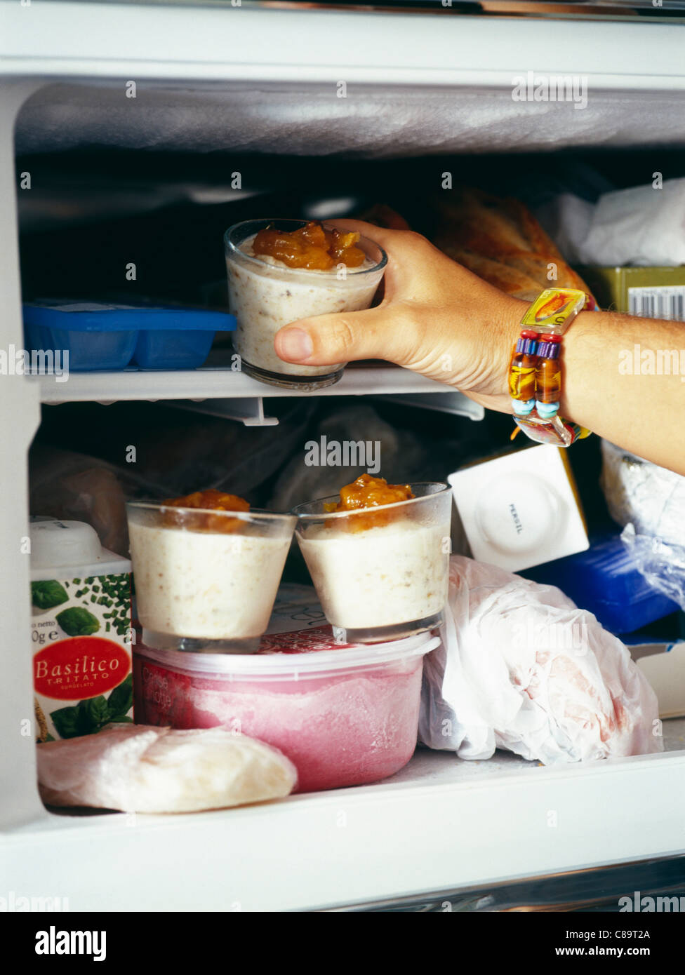 Person taking food out of a freezer Stock Photo