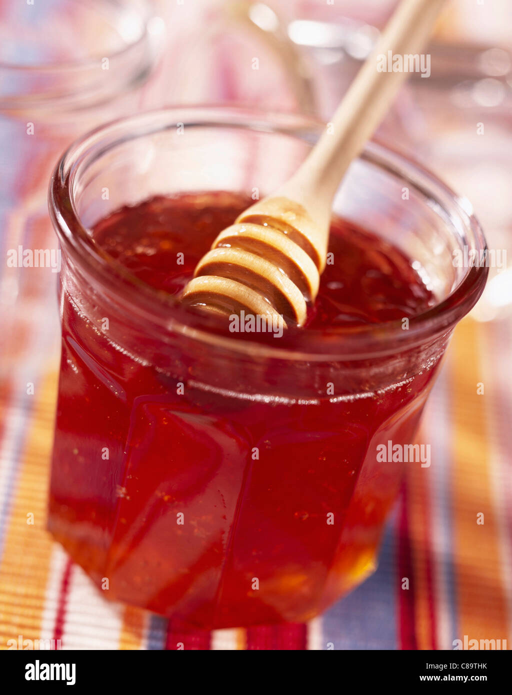 Pot of honey with honey spoon Stock Photo Alamy