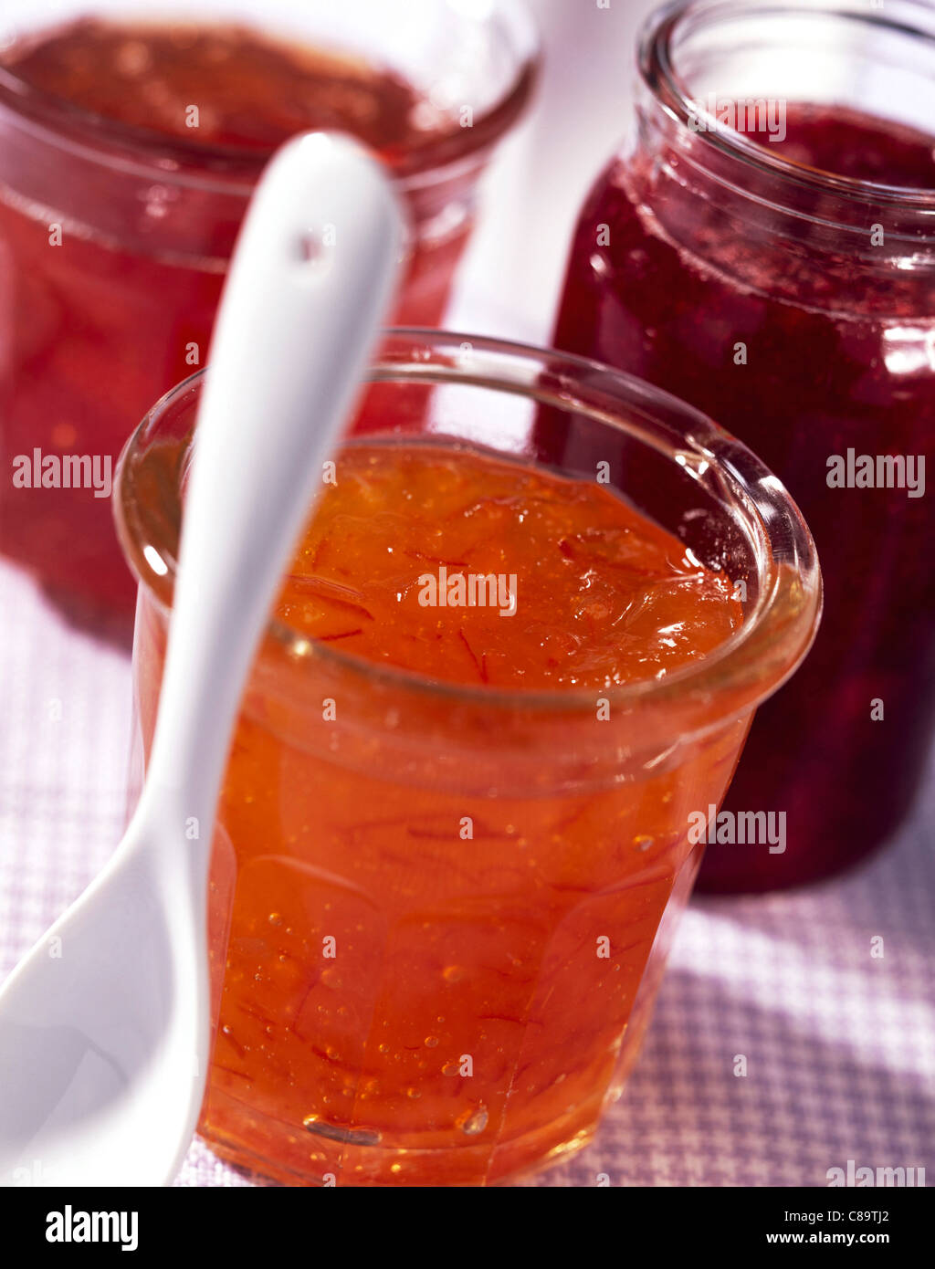 Pots of jam and white spoon Stock Photo