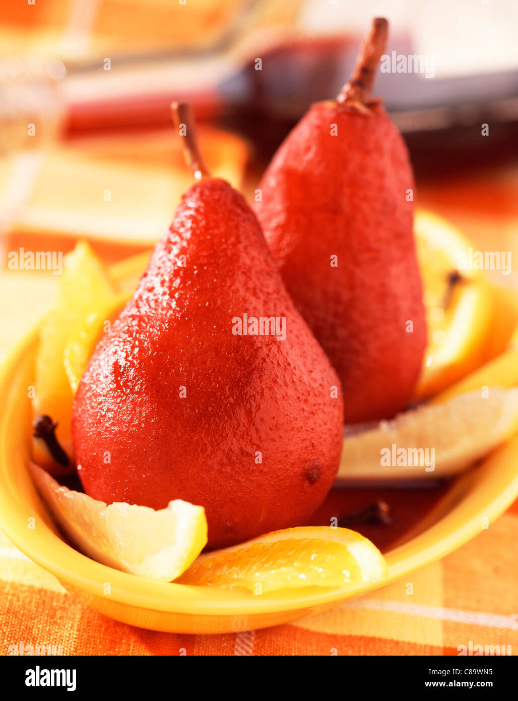 Pears and citrus fruit in spiced red wine Stock Photo