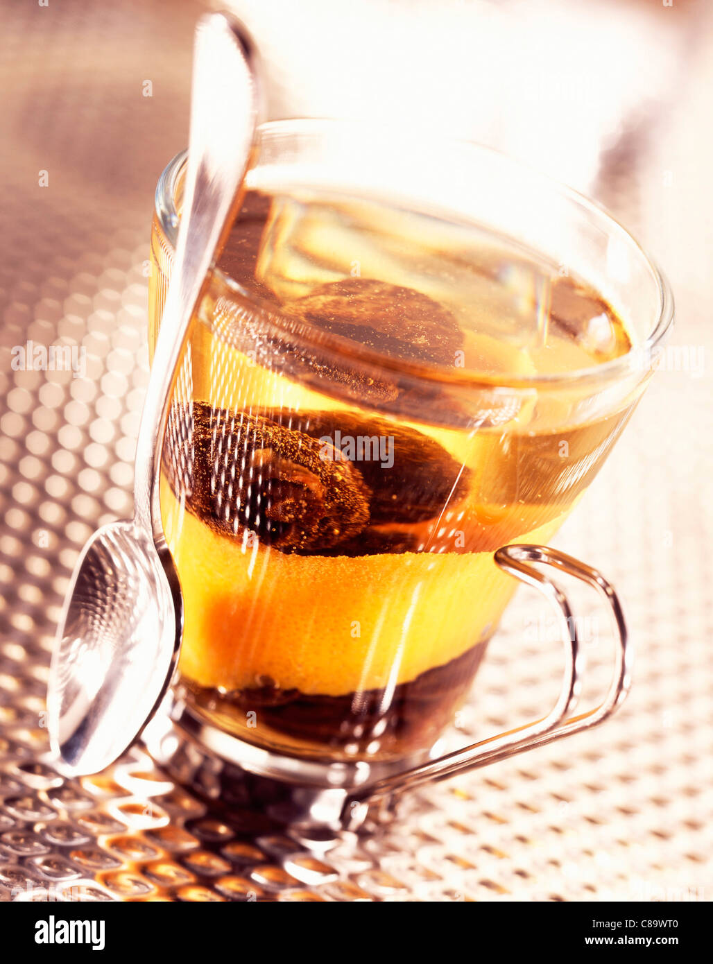 Prunes in tea with orange zest Stock Photo