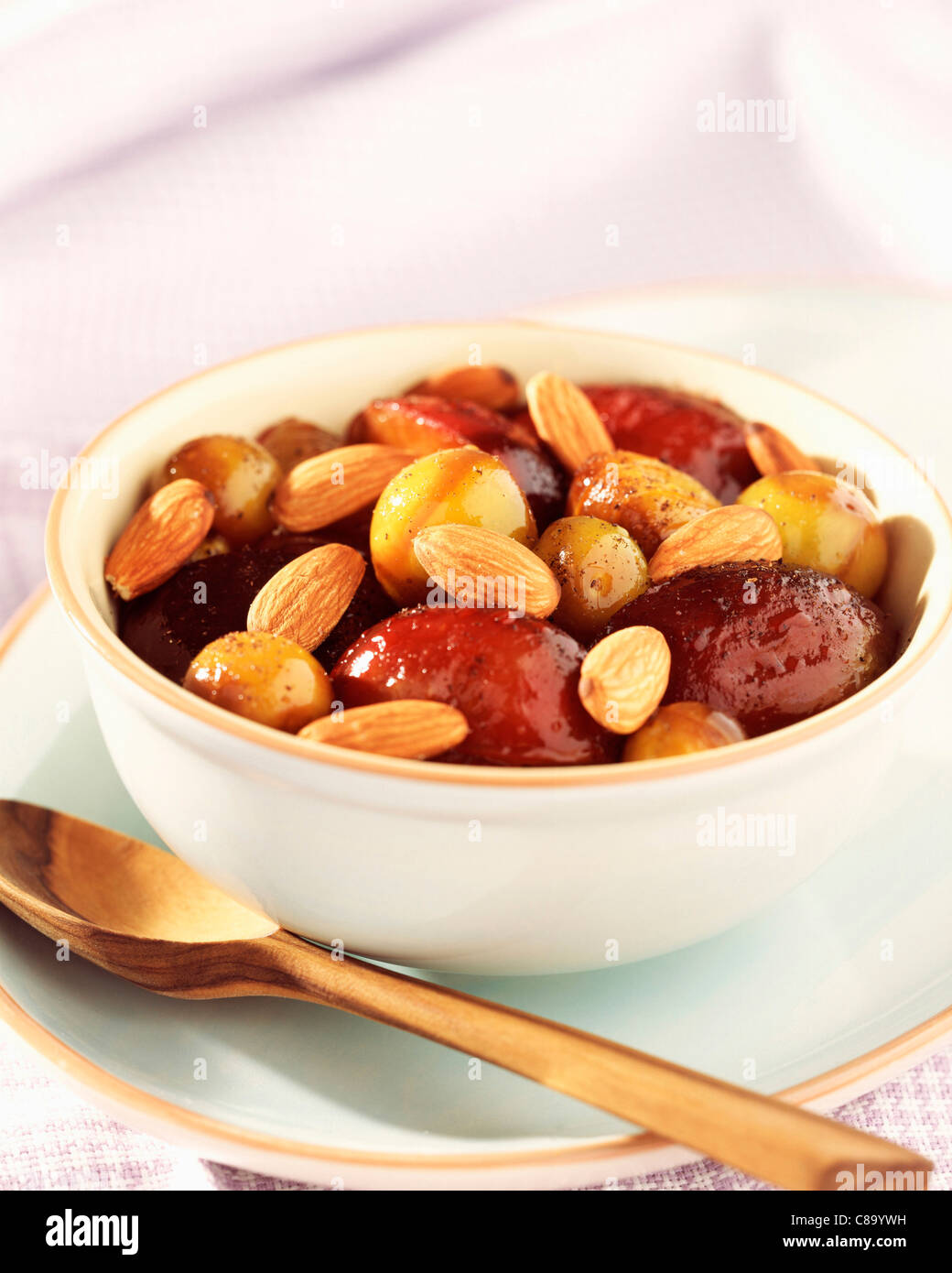 Mirabelle and quetsch plums with orange blossom and grilled almonds Stock Photo