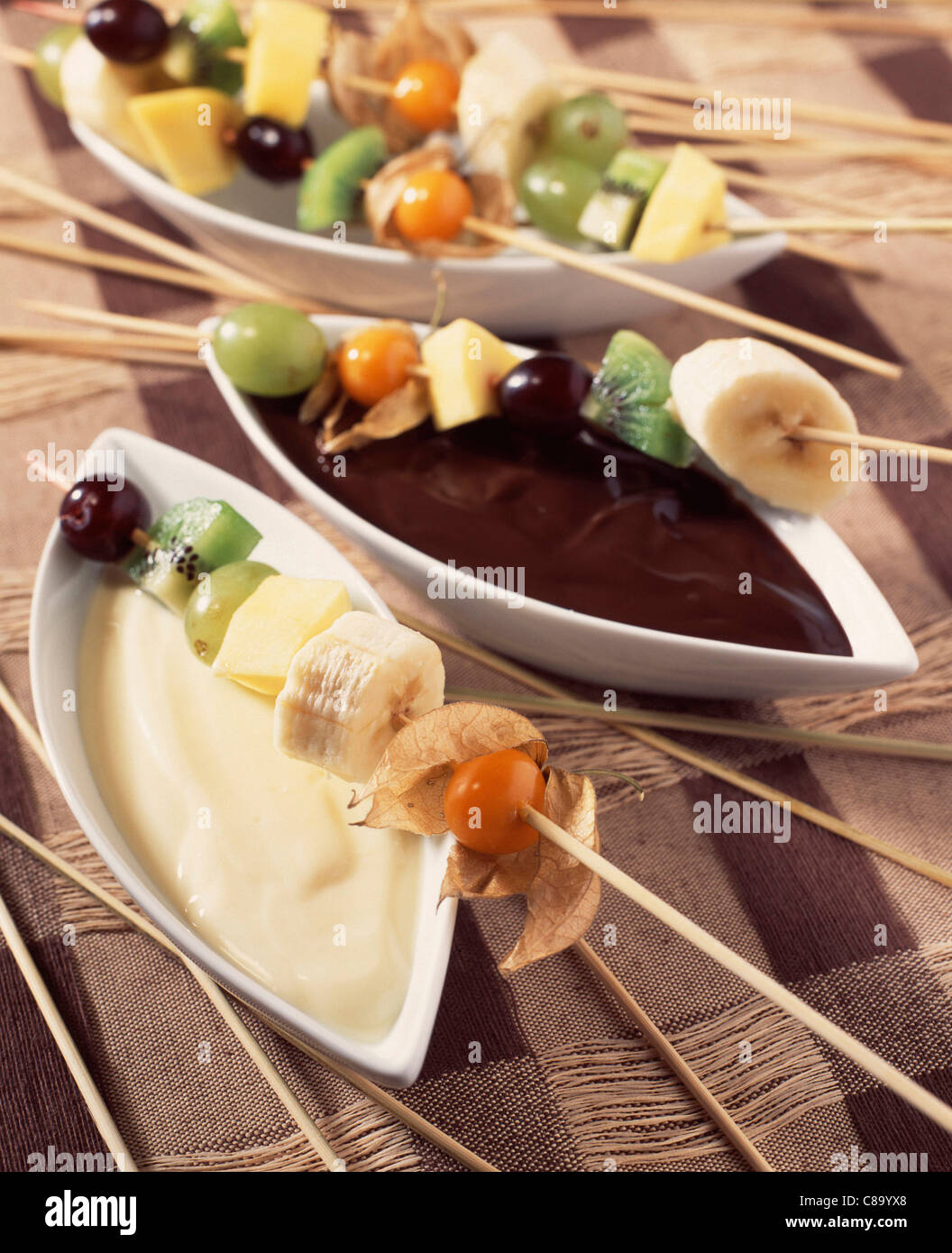 Fruit kebabs with dark and white chocolate sauces Stock Photo Alamy