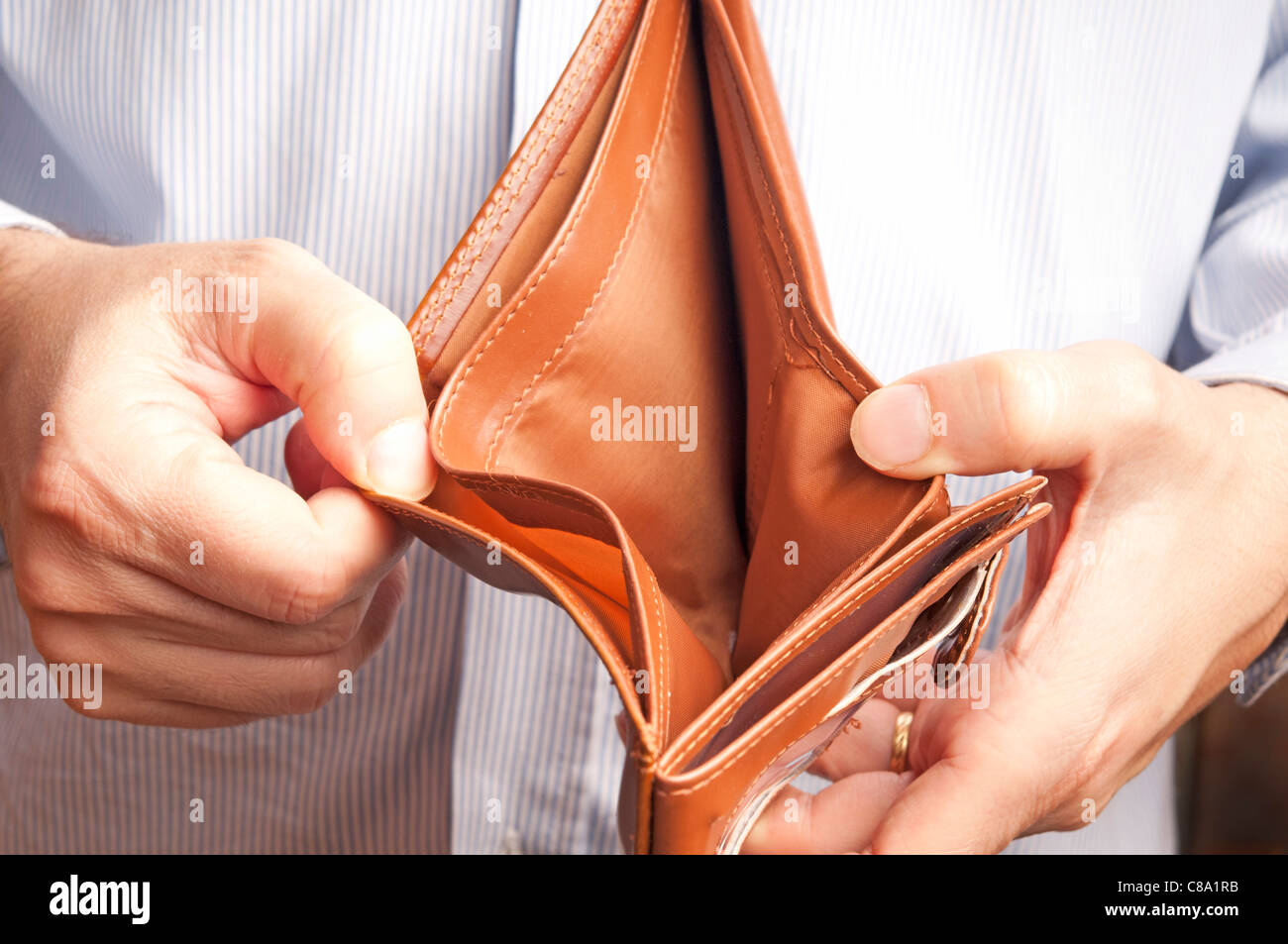 man showing an empty wallet Stock Photo