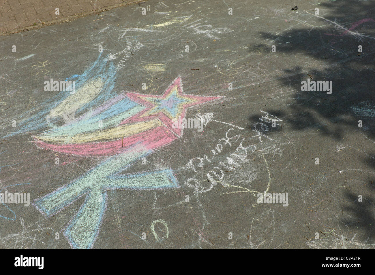 Child's chalk drawing on pavement or path in park playground Stock