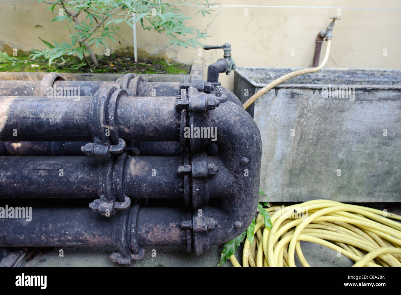 Old cast iron triple greenhouse hot water heating system Stock Photo