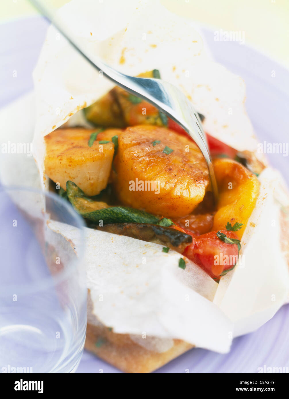 Scallops and vegetables cooked in wax paper Stock Photo Alamy