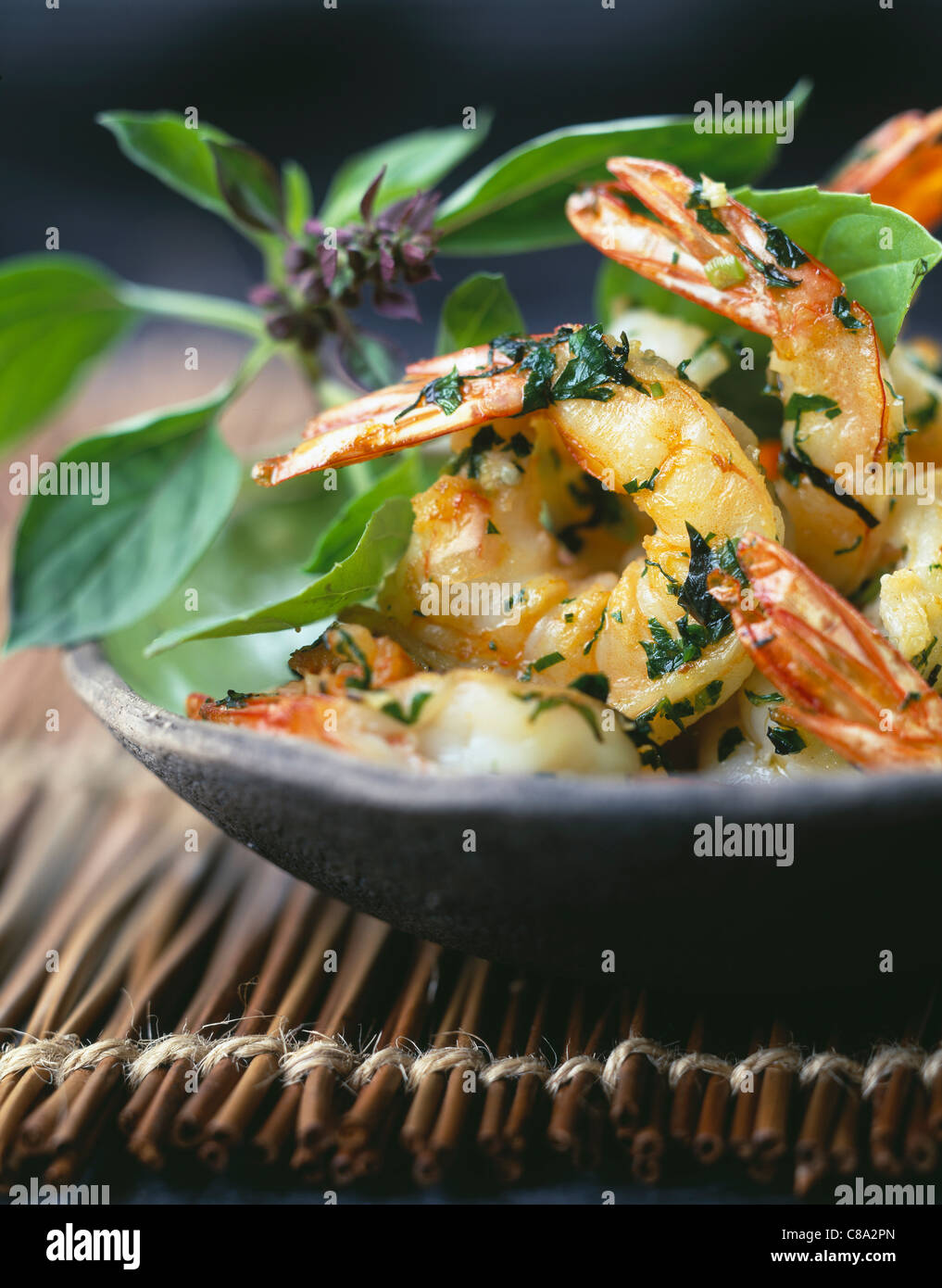 Pan-fried shrimps with chinese basil,flat parsley and coriander Stock Photo