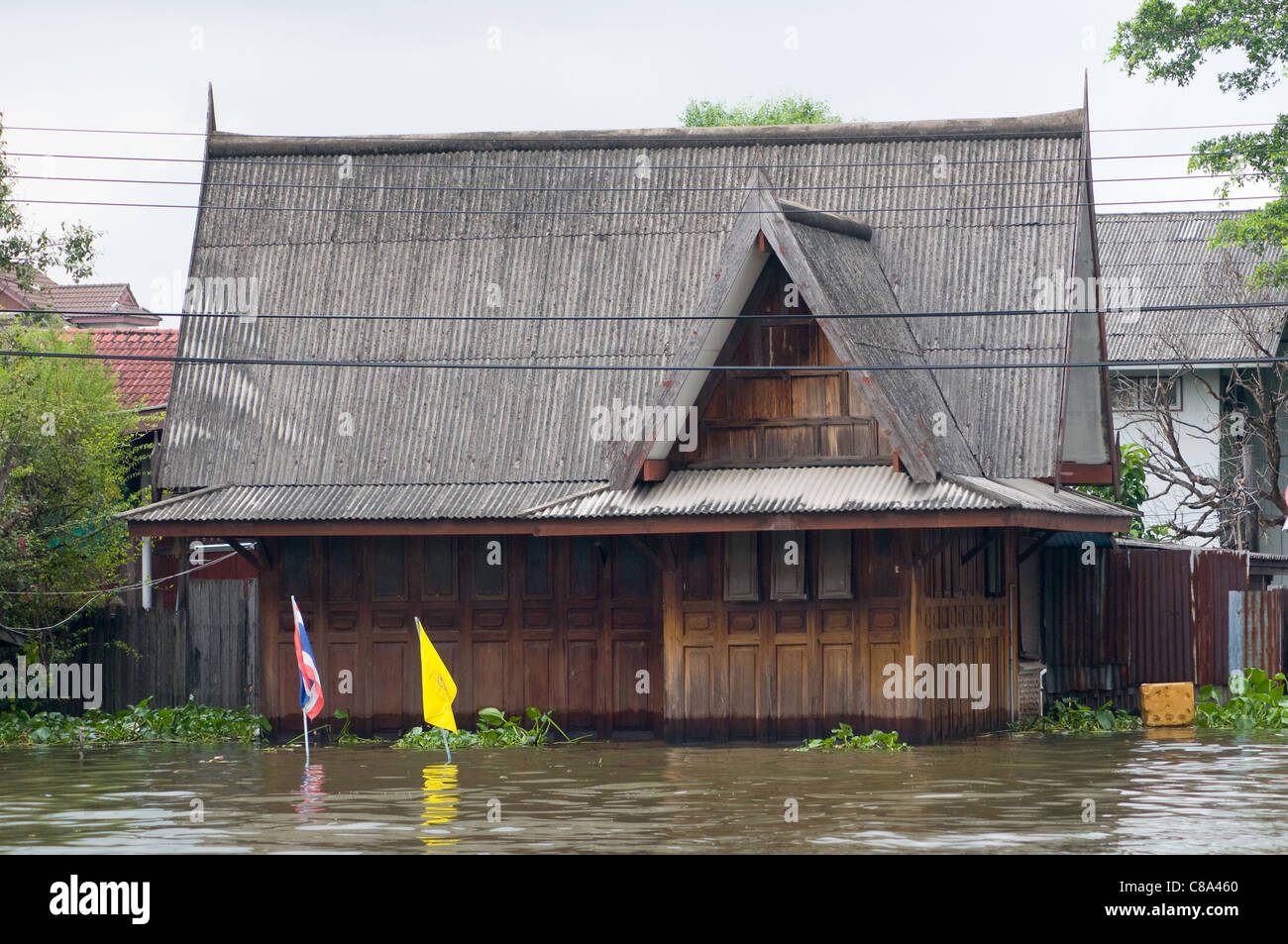 Flooded teak house along a canal in Bangkok during the monsoon season. Stock Photo