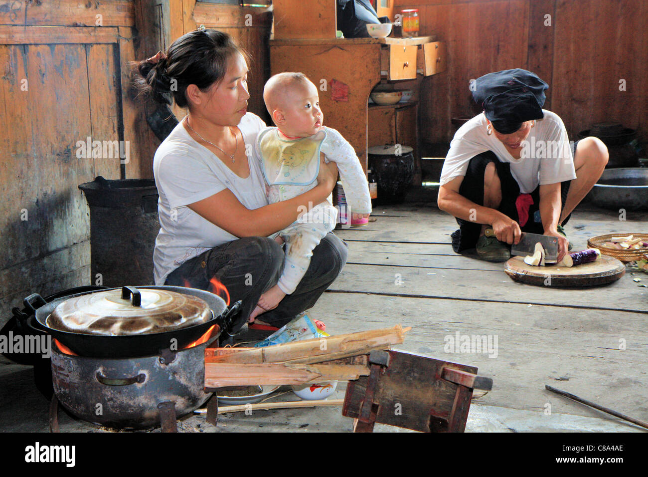 Typical Chinese family cooking inside their house, Ping'an, Guanxi, China Stock Photo