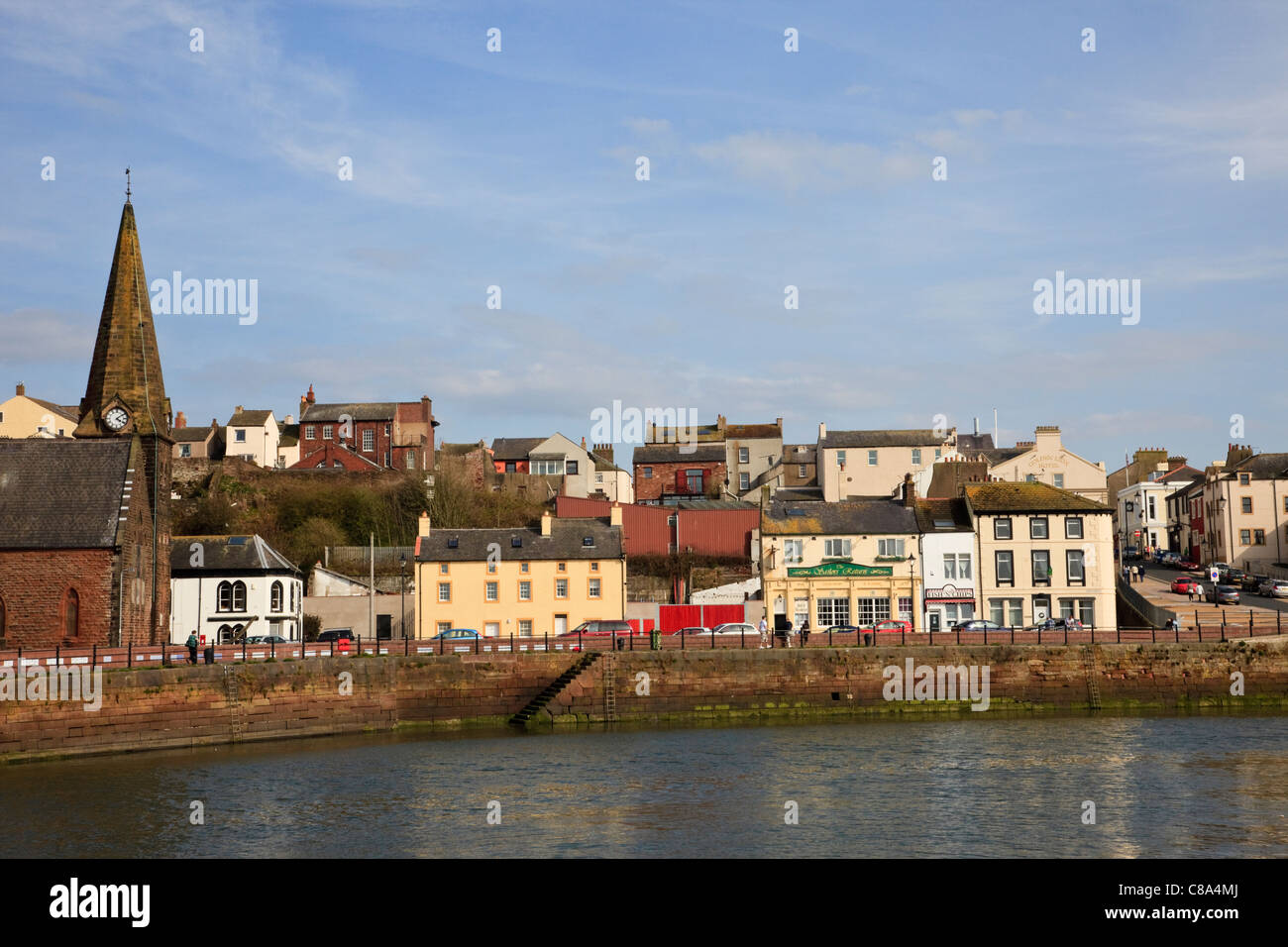 View across River Ellen harbour to the harbourside waterfront town buildings and Christ church. Maryport, Cumbria, England, UK, Britain Stock Photo