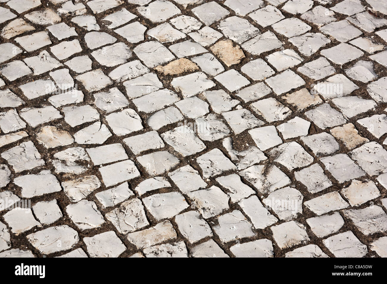 Portuguese cobblestone sidewalk made of cubic stones Stock Photo Alamy
