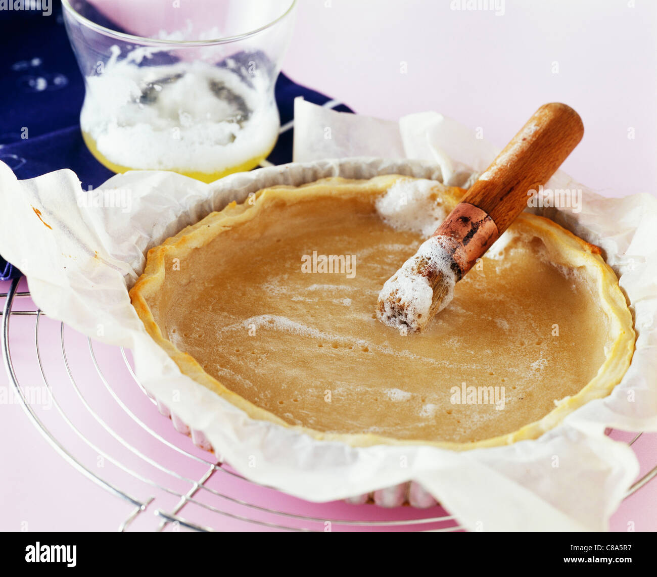 Brushing onto the pastry the beaten egg whites Stock Photo Alamy