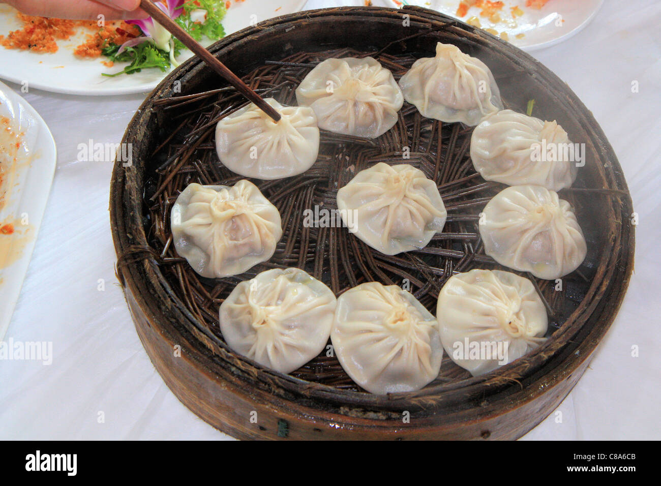 Steamed dumplings in bamboo basket, China Stock Photo Alamy