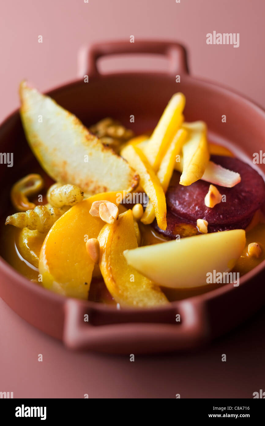 Small casserole dish of chinese artichokes,apple,beetroot and hazelnuts Stock Photo