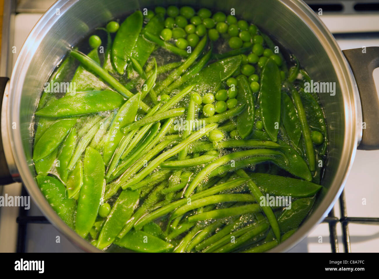 green vegetables cooking in boiling water Stock Photo Alamy