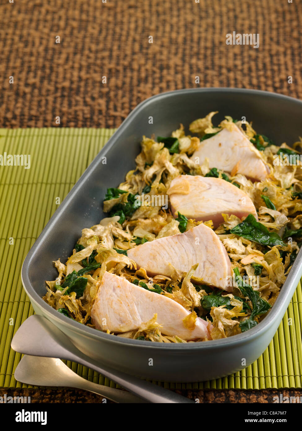 Ovenbaked swordfish with spinach and artichokes Stock Photo Alamy