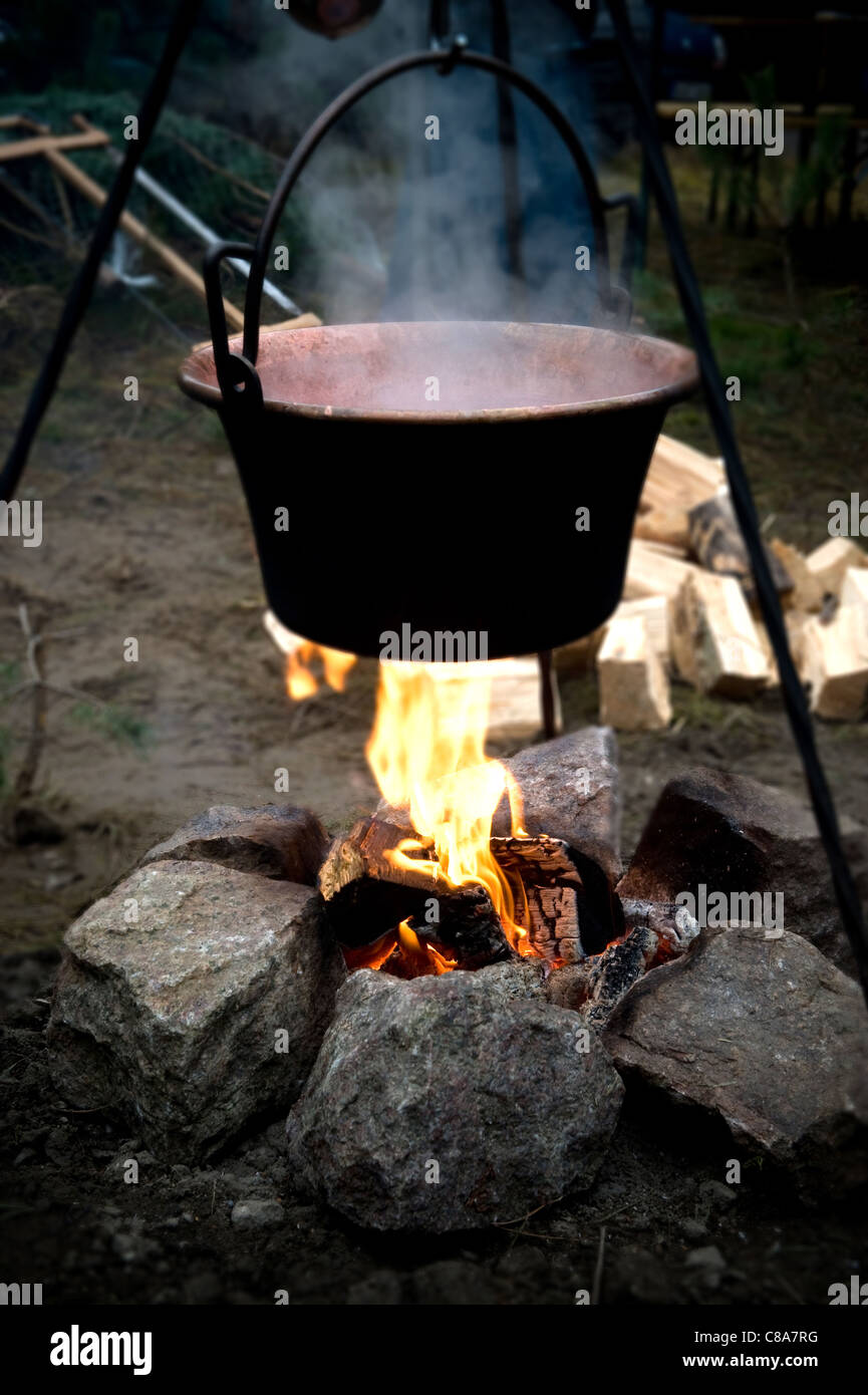 Mulled wine cooking in a pot over a fire Stock Photo Alamy