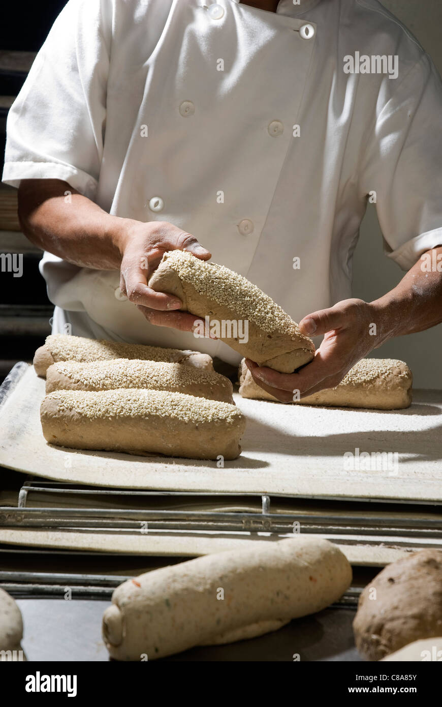 Baker working in his bakery Stock Photo