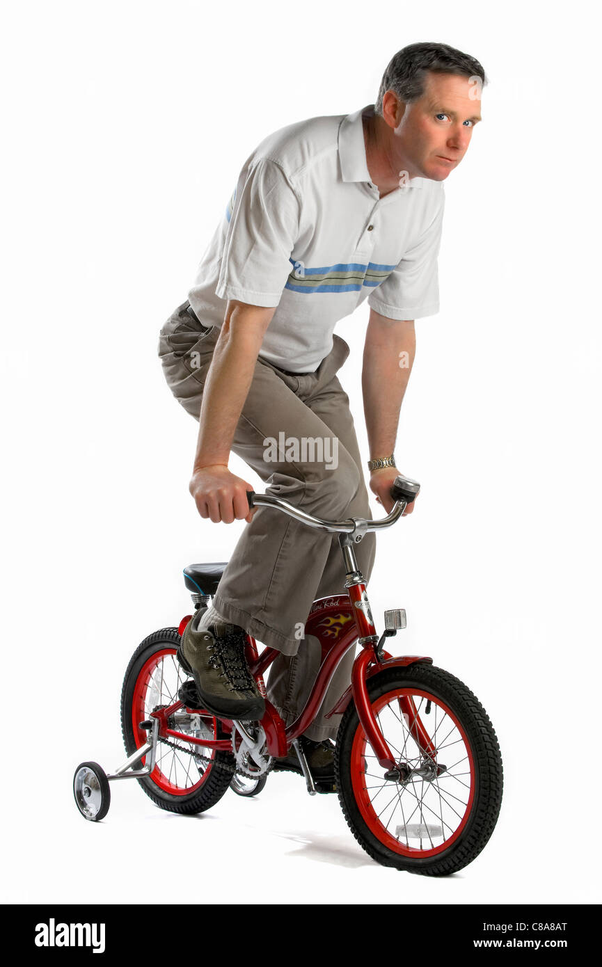 Adult man on children bicycle Stock Photo