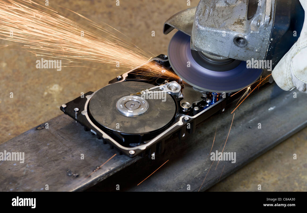 grinding on open computer hard drive. sparks flying away Stock Photo