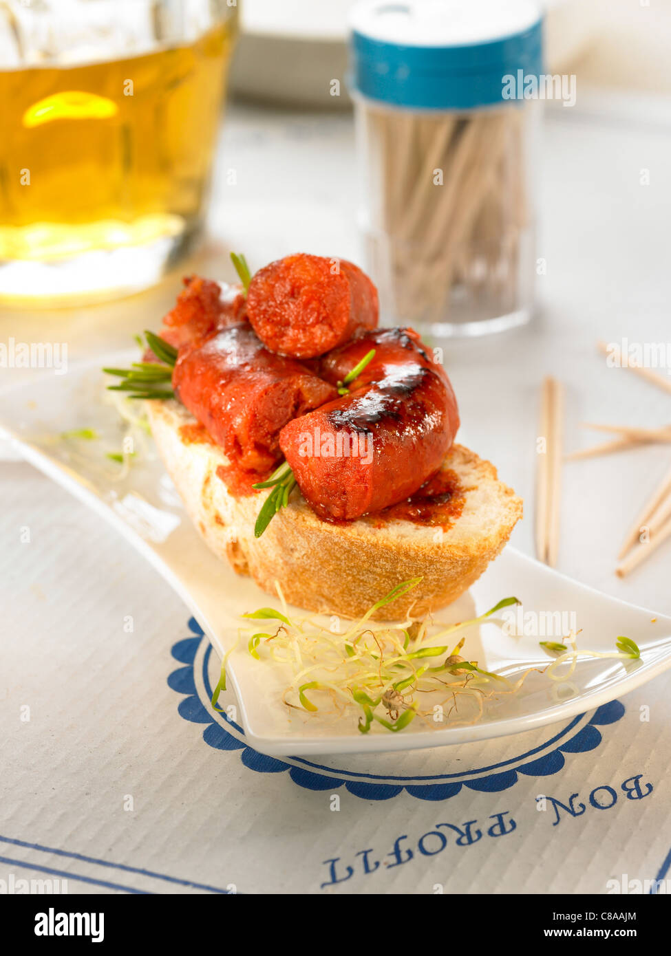 Chorizo cooked in cider on a slice of bread Stock Photo