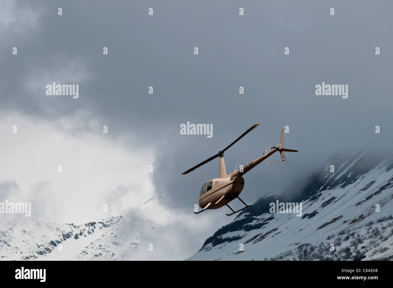 Robinson R44 Raven II helicopter in flight, Valdez Flyin and Air Show