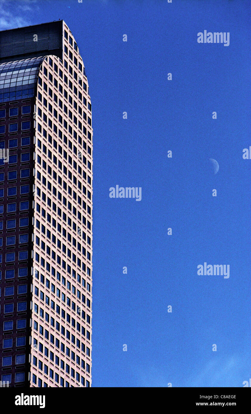 The Wells Fargo Center skyscraper in Denver, Colorado, with the moon. Shot on Fuji 200 film. Stock Photo