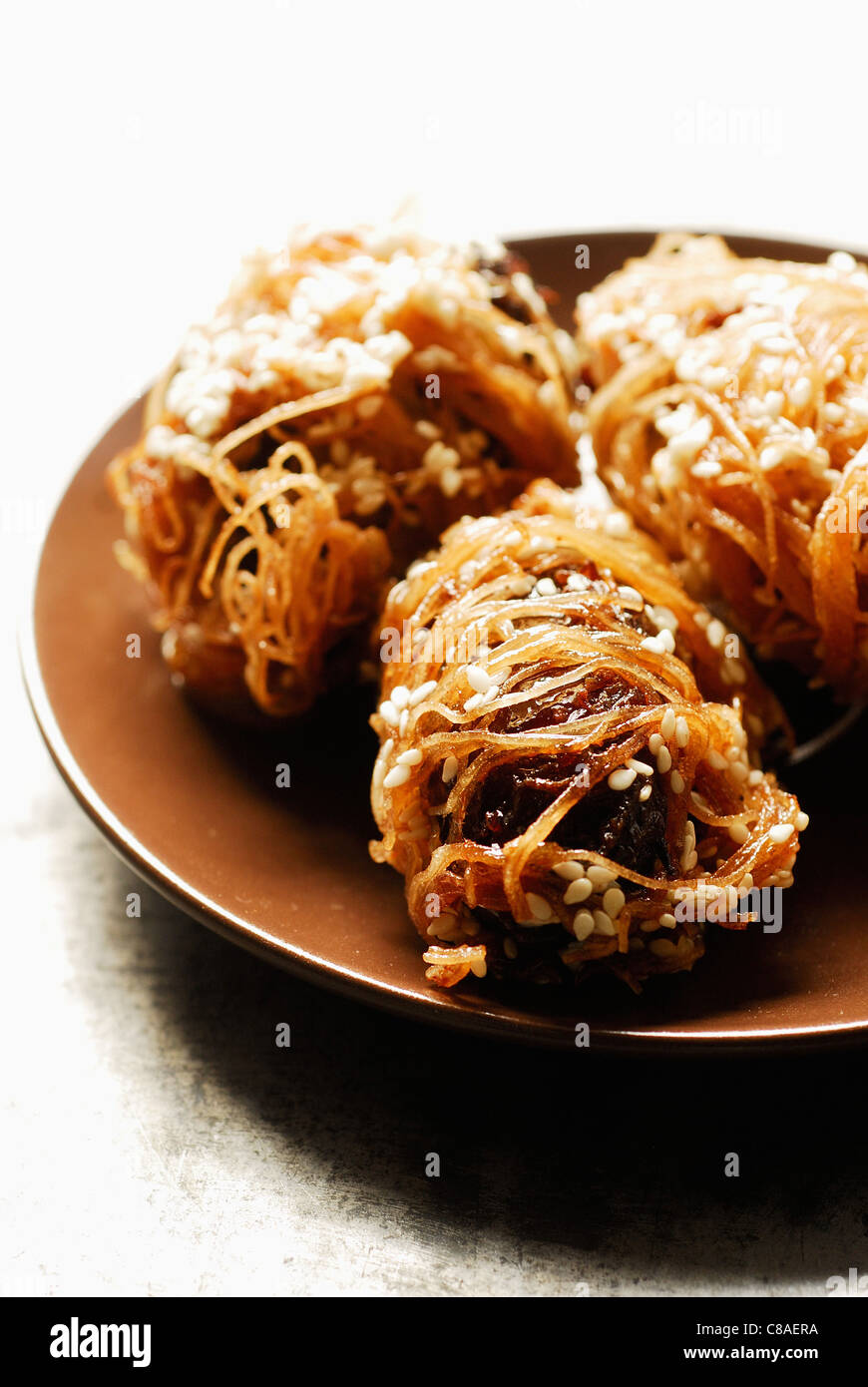 Crunchy dates with honey and sesame seeds Stock Photo